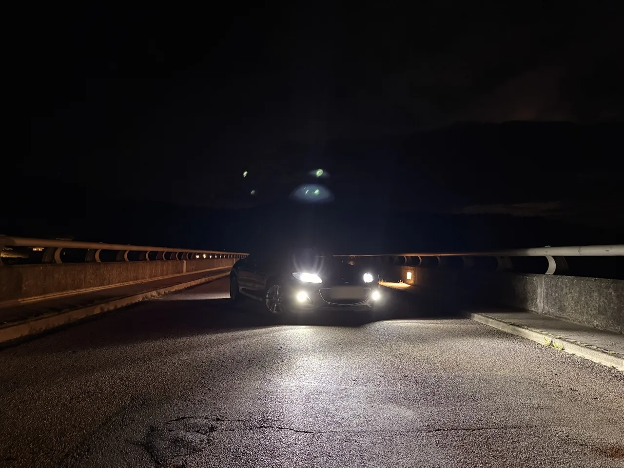 Mazda MX-5 NC phares allumés, de nuit sur le barrage de Villerest.